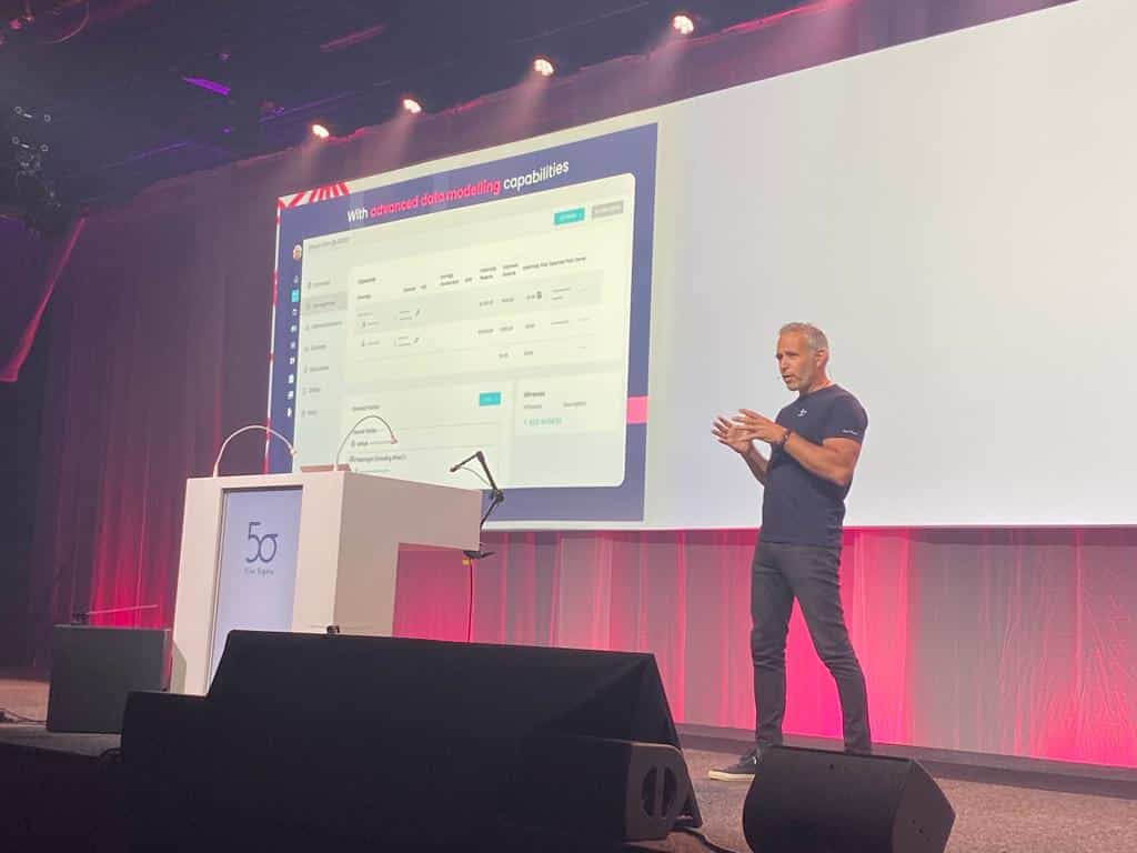 Speaker presenting Five Sigma data modeling capabilities on stage